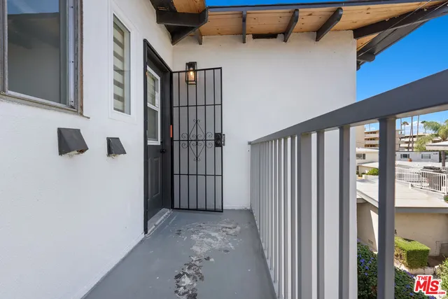 a view of small space with wooden floor and windows