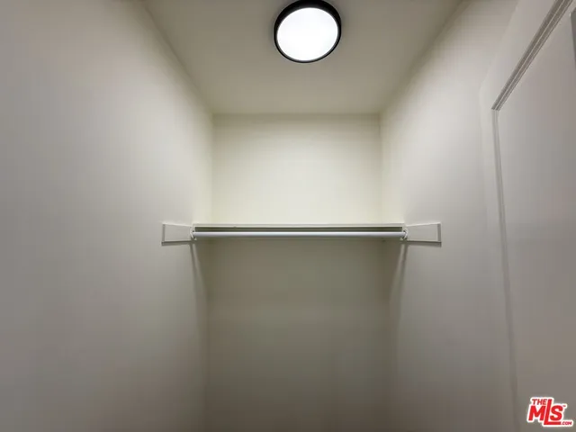 a view of a room with wooden floor and a ceiling fan