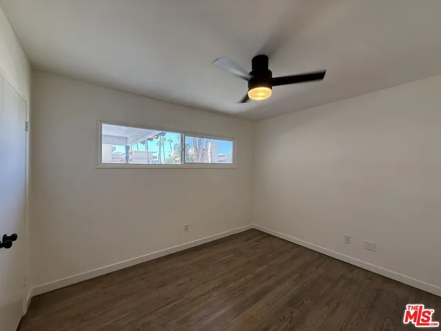 a view of a room with wooden floor and window