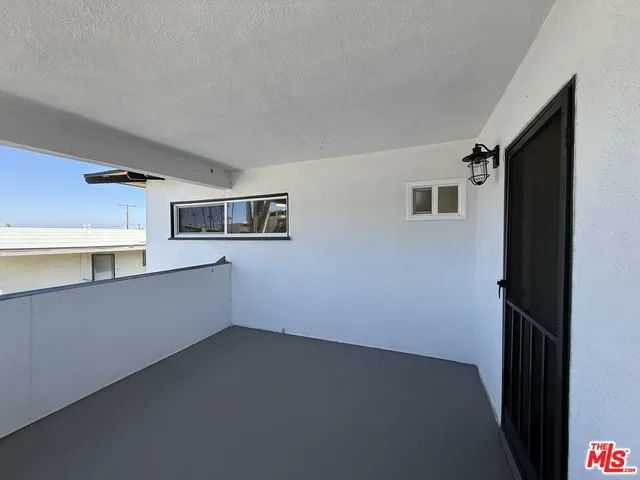a kitchen with granite countertop a sink cabinets and stainless steel appliances