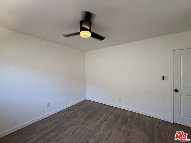 a view of a kitchen with a sink and a refrigerator