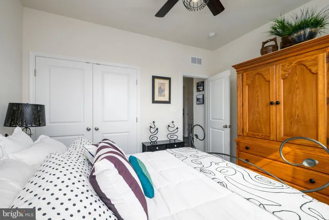 a bedroom with a bed and a dresser