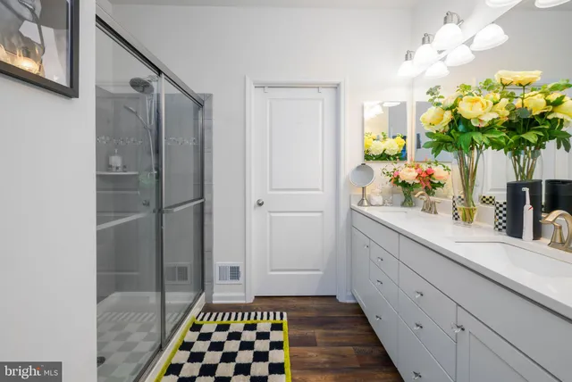a bathroom with a sink a mirror and a shower