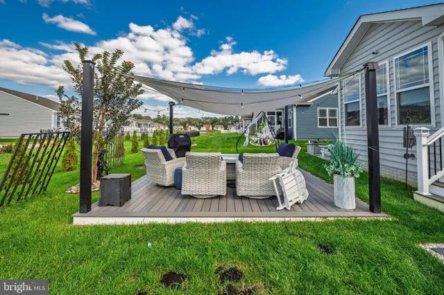 a view of a house with backyard sitting area and garden