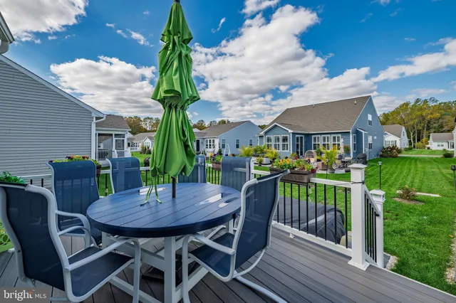 a view of a patio with a table chairs and a garden