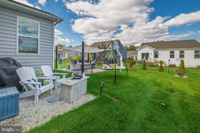 a view of a house with a yard porch and sitting area