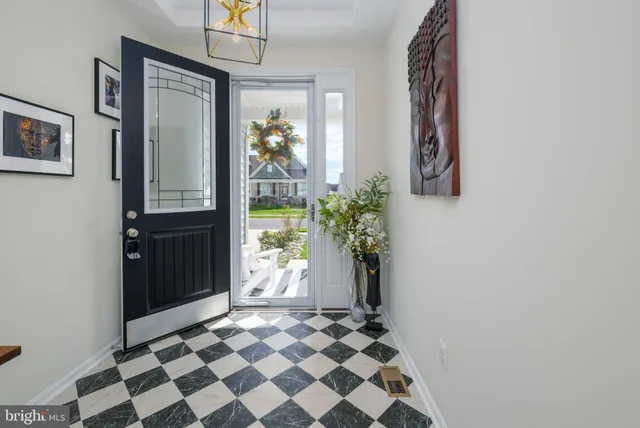 a bathroom with a black and white checkered floor