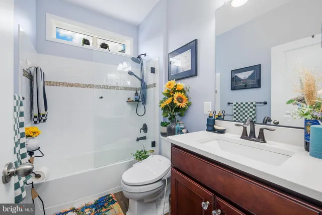 a bathroom with a sink mirror vanity and toilet