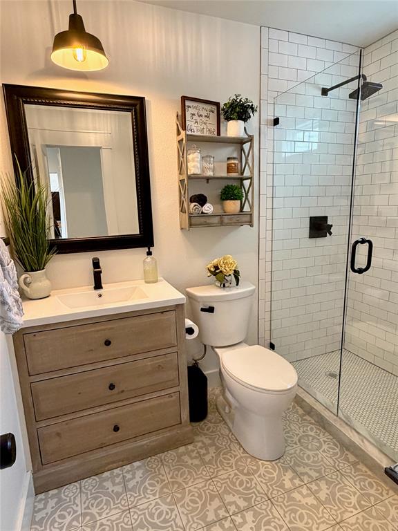 1304 Tinker Road Colleyville, TX 76034 - Photo 15 of 28 a bathroom with a toilet sink and shower