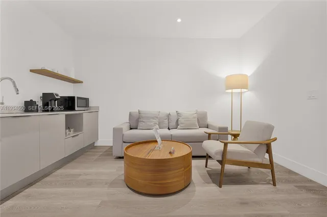 a living room with furniture and a lamp