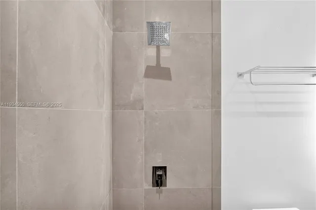 a room with gym equipment and large windows