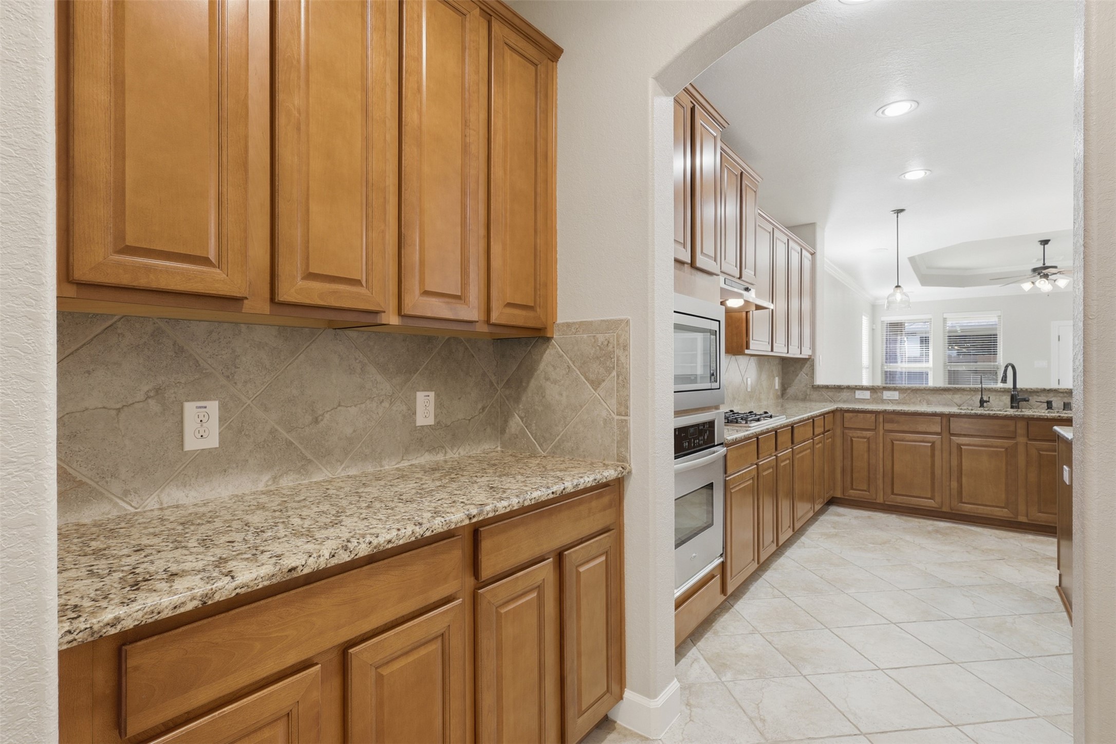 721 Rufina Street League City, TX 77573 - Photo 6 of 33 A thoughtfully designed butler's pantry adds both beauty and functionality, offering generous cabinetry, granite countertops, and additional prep and serving space. Conveniently positioned between the dining room and kitchen, it's ideal for entertaining with ease.