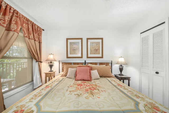 a bedroom with a large bed and a large window