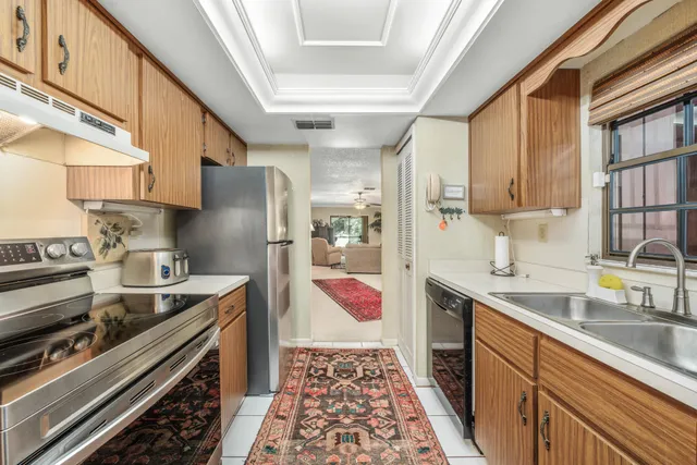 a kitchen with a sink stove and refrigerator