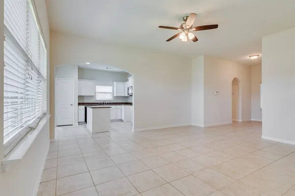 a view of an empty room with a ceiling fan