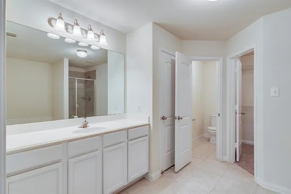 a bathroom with a double vanity sink and a mirror