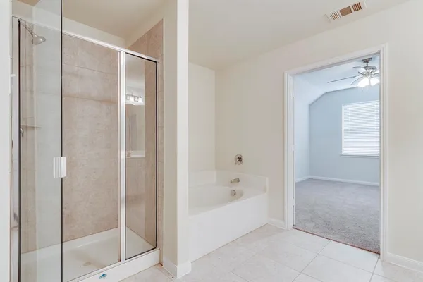 a bathroom with a bathtub and shower