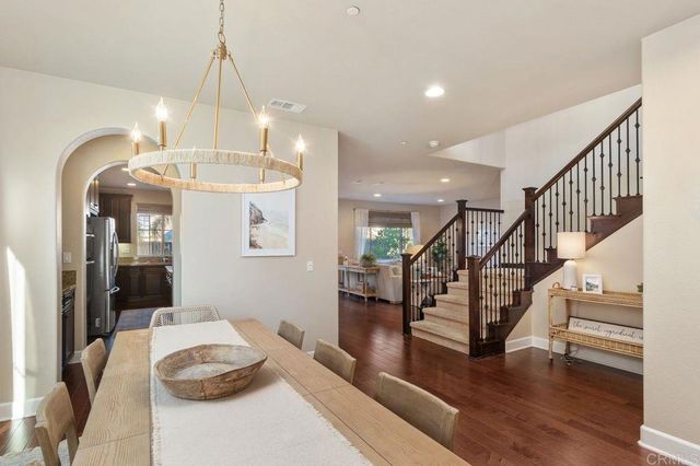 a living room with furniture a fireplace and a large window