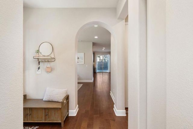 a kitchen with a sink appliances and wooden floor
