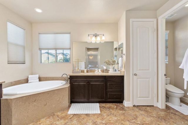 a view of a swimming pool with sitting area and furniture