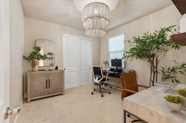 a view of a patio with table and chairs potted plants and large tree