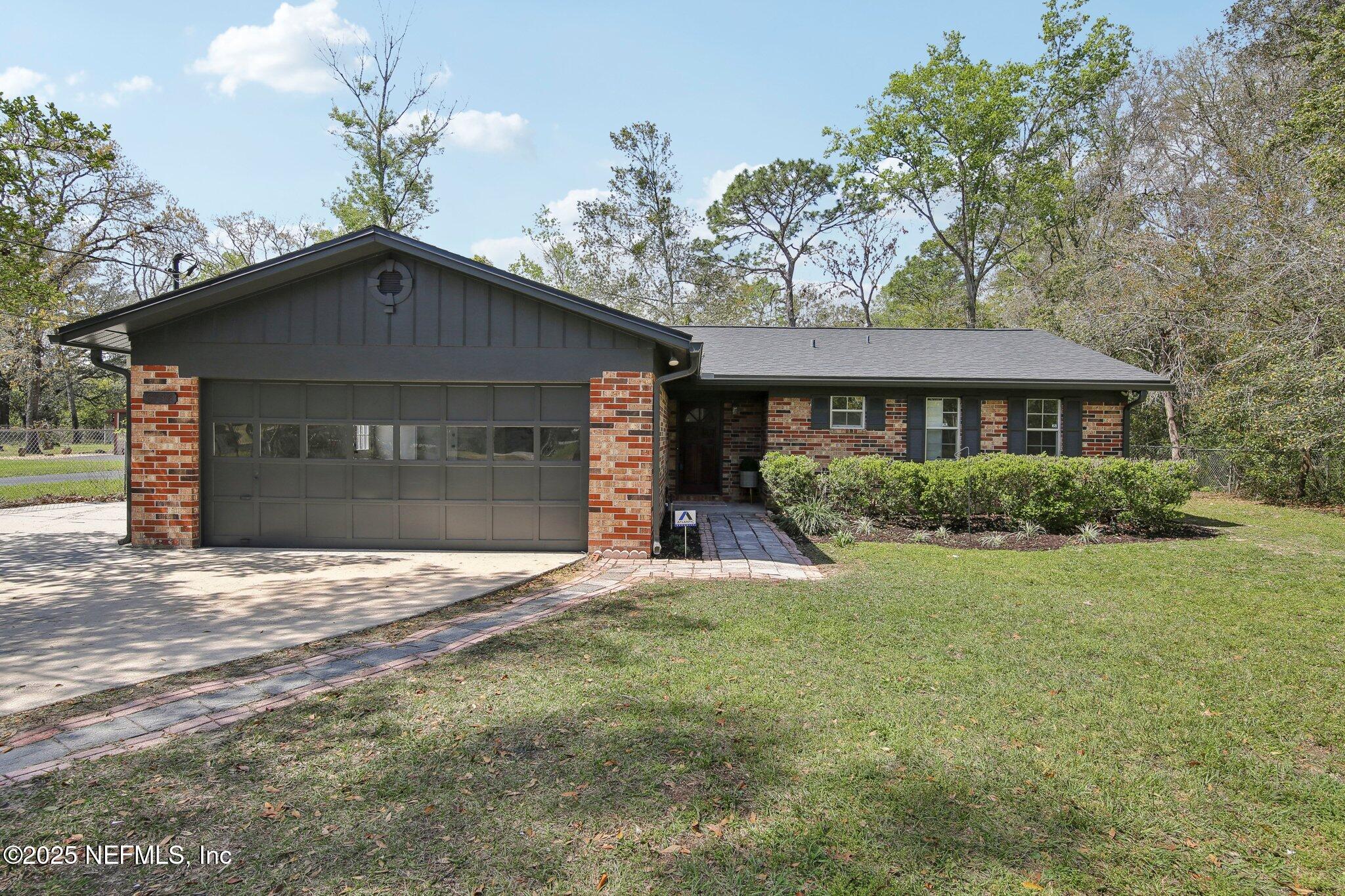 8138 Westport Road Jacksonville, FL 32244 - Photo 1 of 45 a front view of a house with a yard and garage