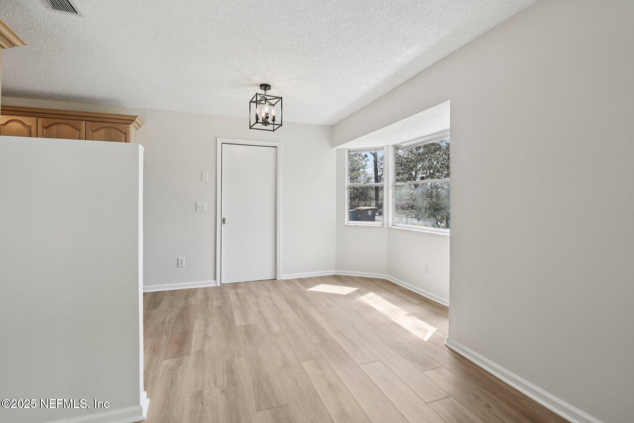 8138 Westport Road Jacksonville, FL 32244 - Photo 11 of 45 a view of an empty room with wooden floor and a window