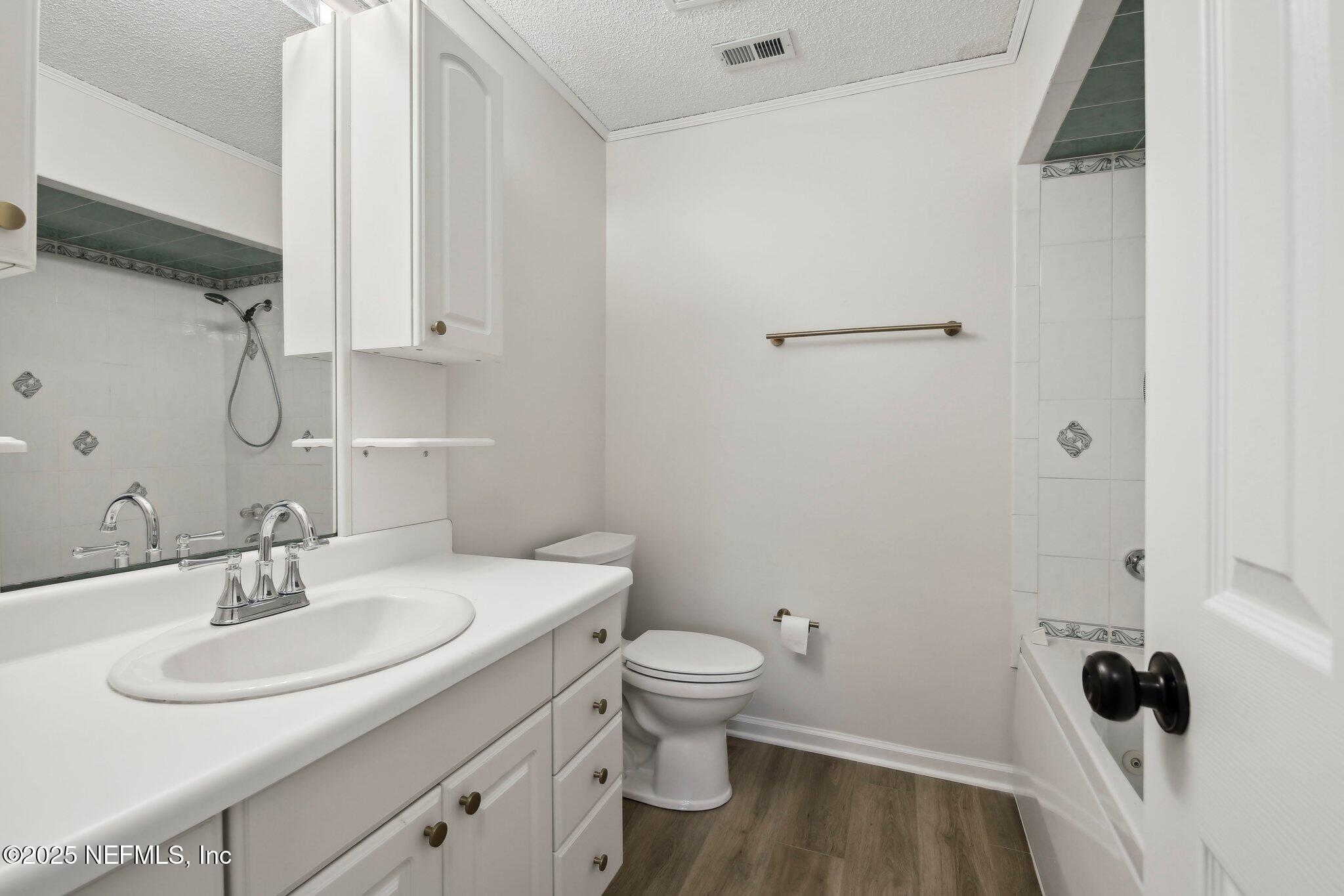 8138 Westport Road Jacksonville, FL 32244 - Photo 13 of 45 a bathroom with a sink toilet and vanity