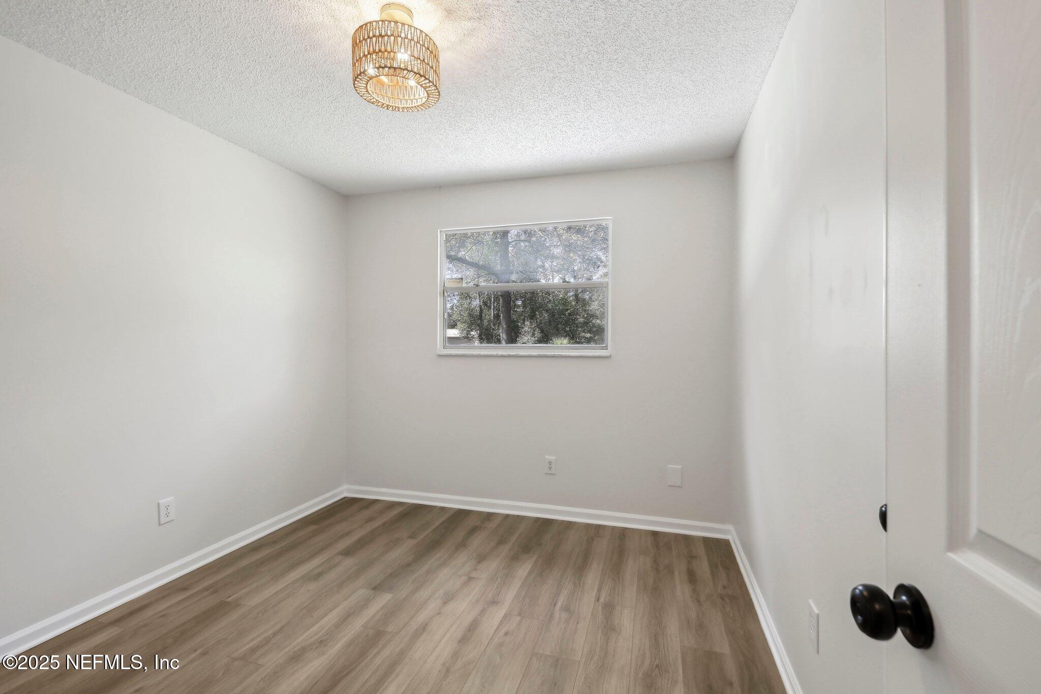 8138 Westport Road Jacksonville, FL 32244 - Photo 14 of 45 a view of empty room with wooden floor