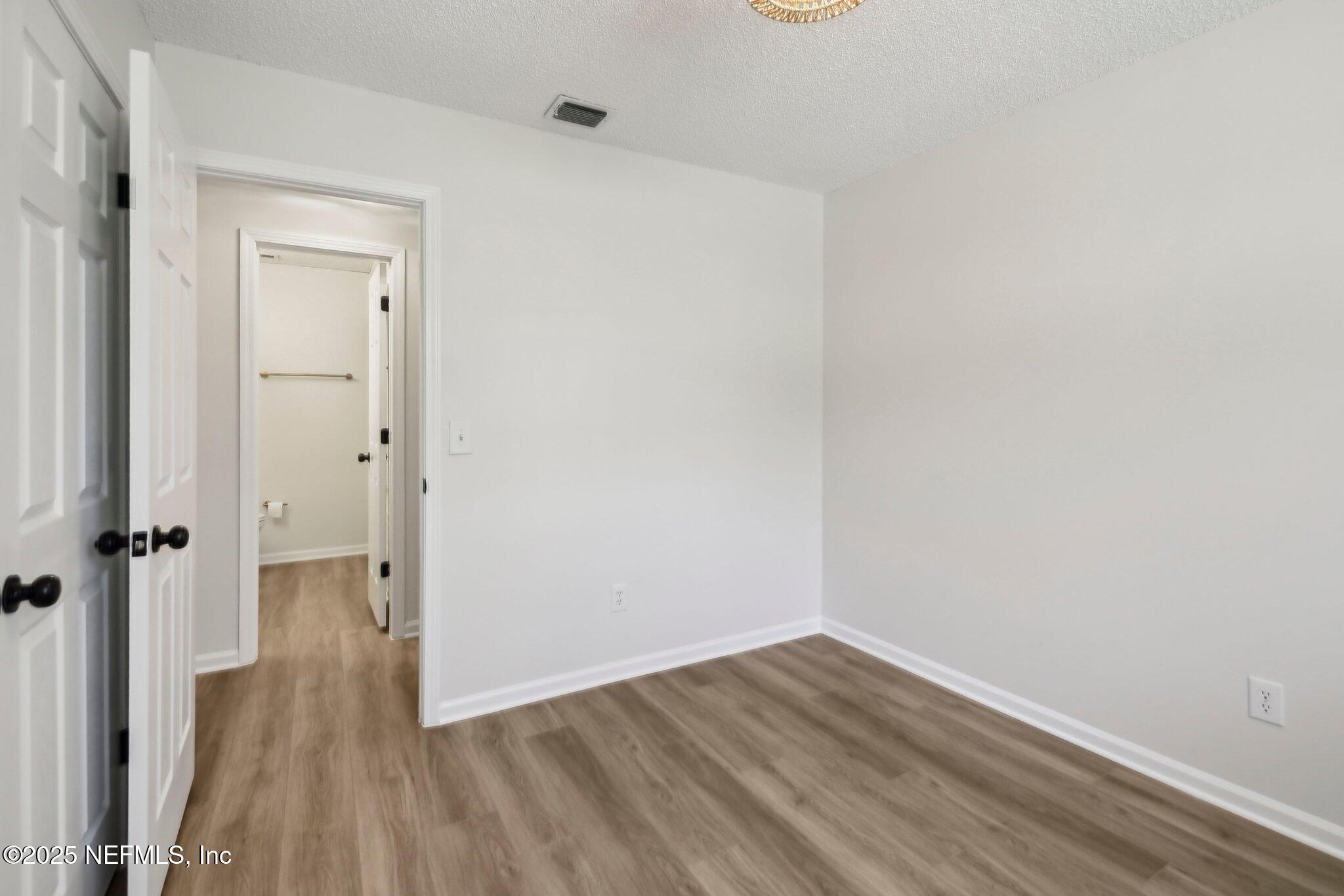 8138 Westport Road Jacksonville, FL 32244 - Photo 17 of 45 a view of a room with wooden floor