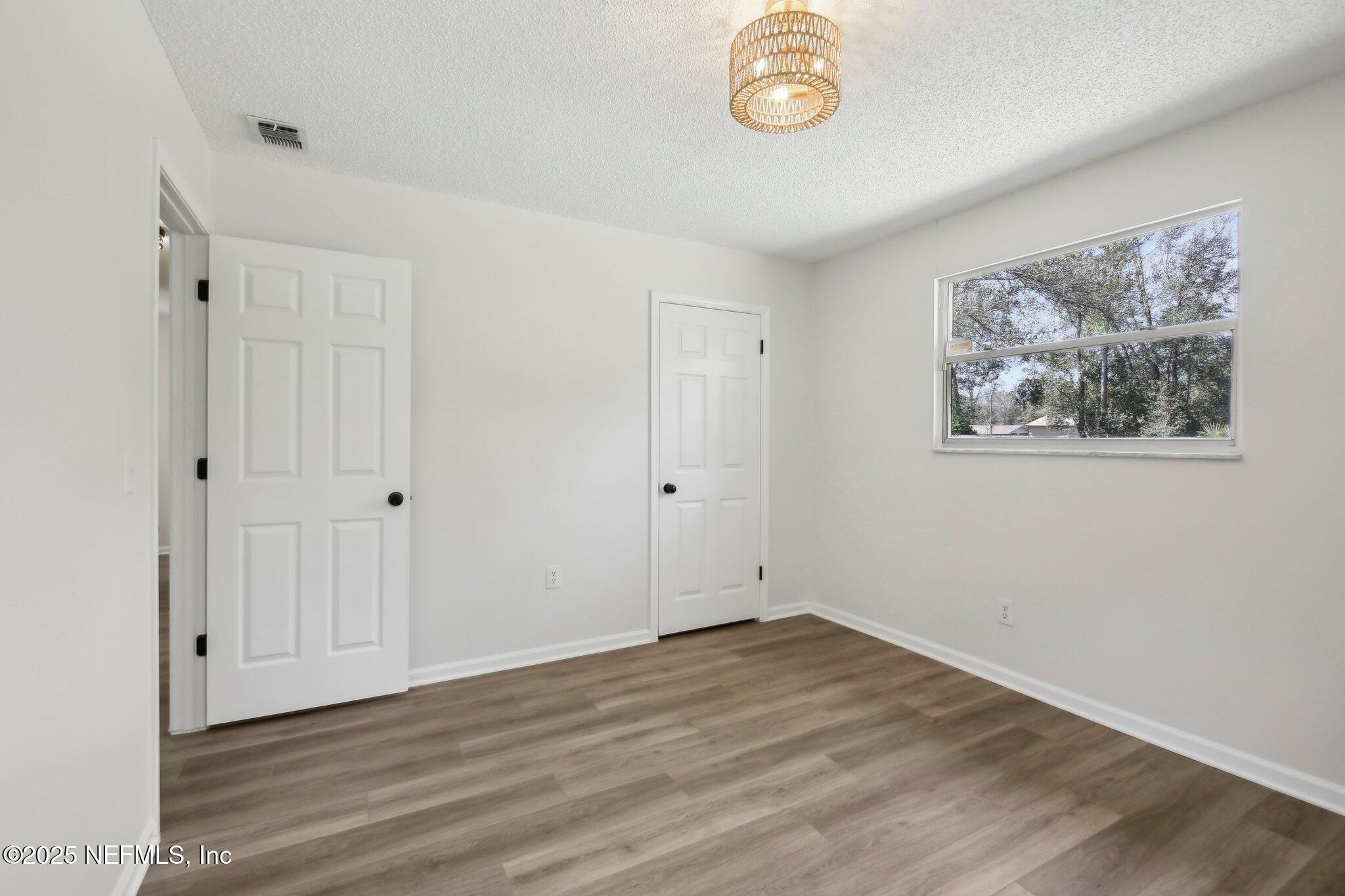 8138 Westport Road Jacksonville, FL 32244 - Photo 19 of 45 a view of room with wooden floor