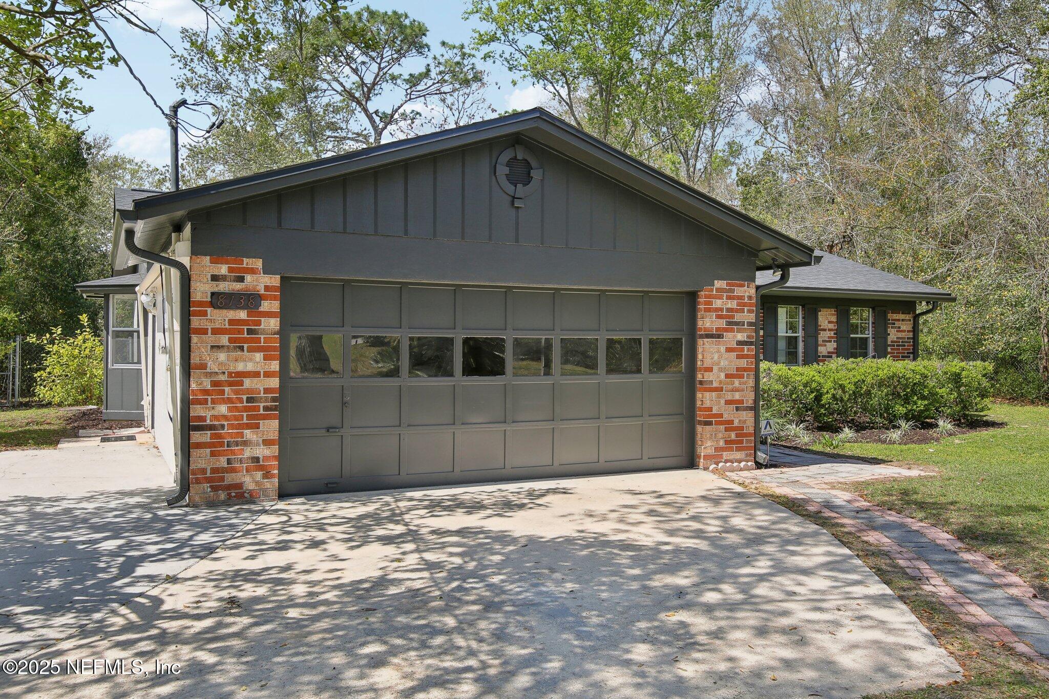 8138 Westport Road Jacksonville, FL 32244 - Photo 2 of 45 a front view of a house with a yard