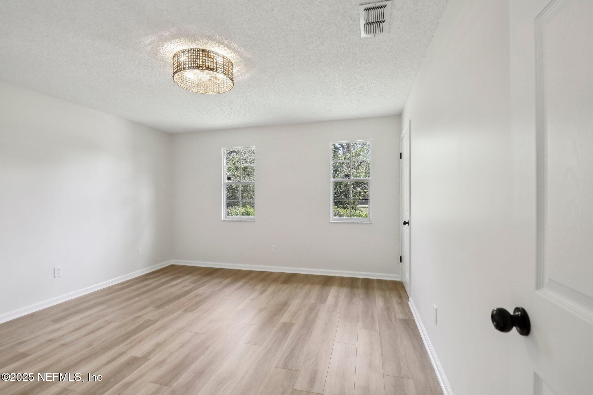 8138 Westport Road Jacksonville, FL 32244 - Photo 21 of 45 an empty room with windows