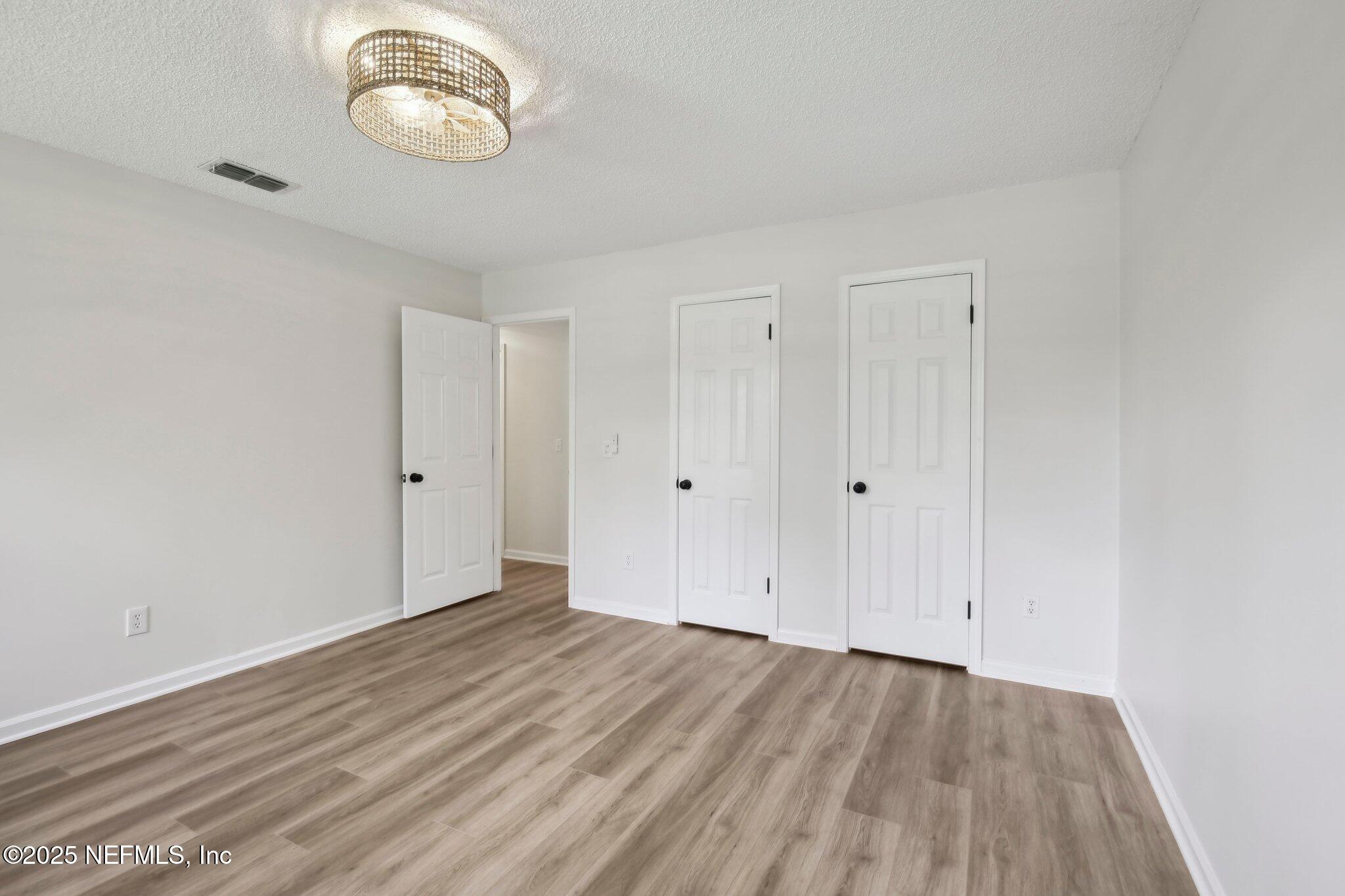 8138 Westport Road Jacksonville, FL 32244 - Photo 22 of 45 a view of a room with wooden floor