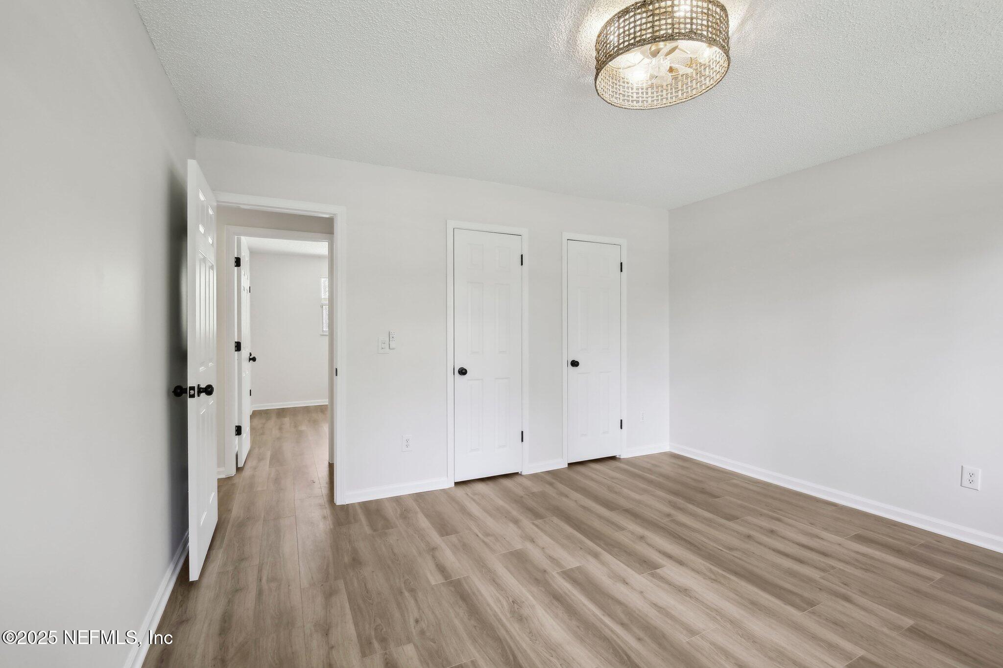 8138 Westport Road Jacksonville, FL 32244 - Photo 23 of 45 wooden floor in an empty room