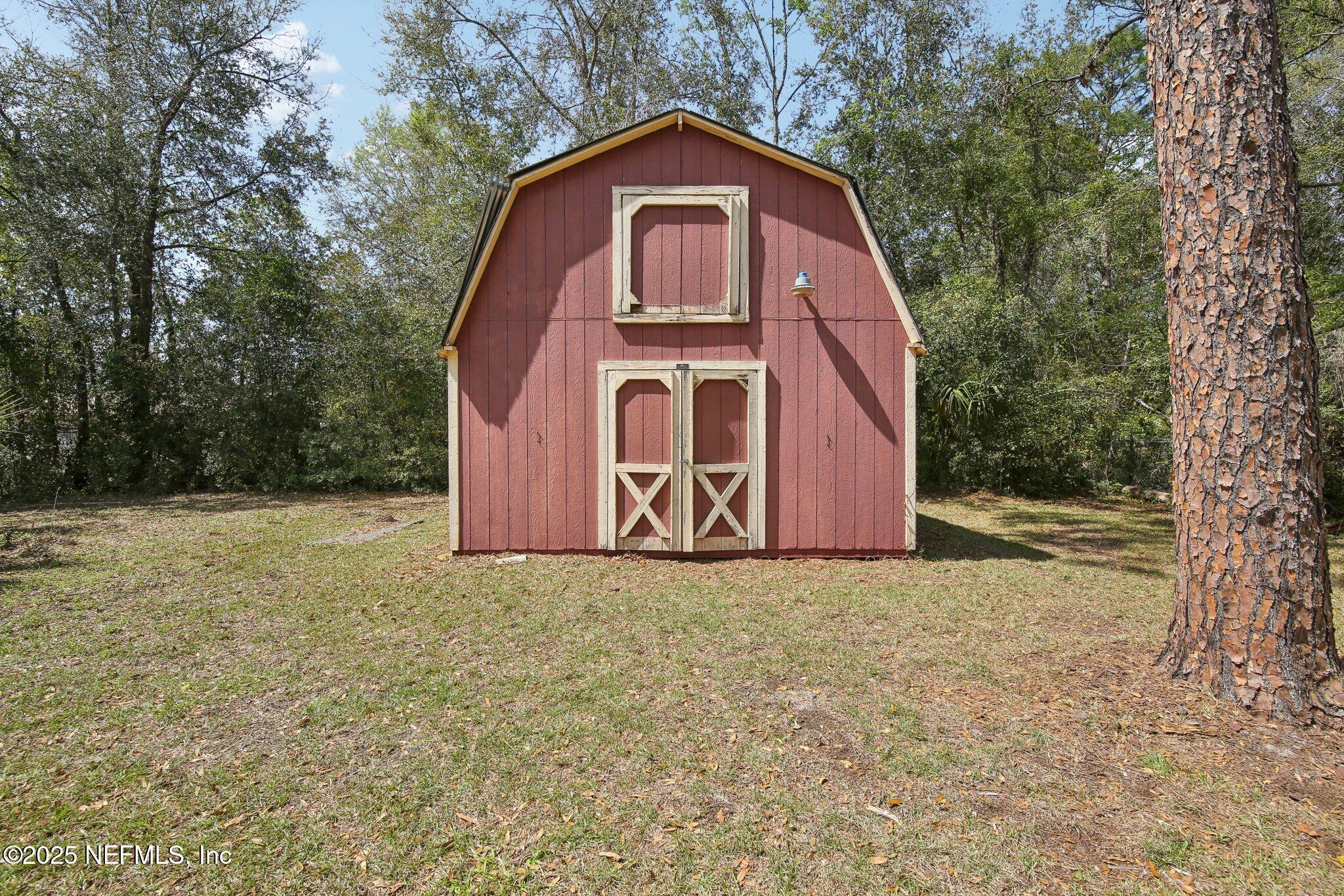 8138 Westport Road Jacksonville, FL 32244 - Photo 28 of 45 a view of a house with a yard and large trees