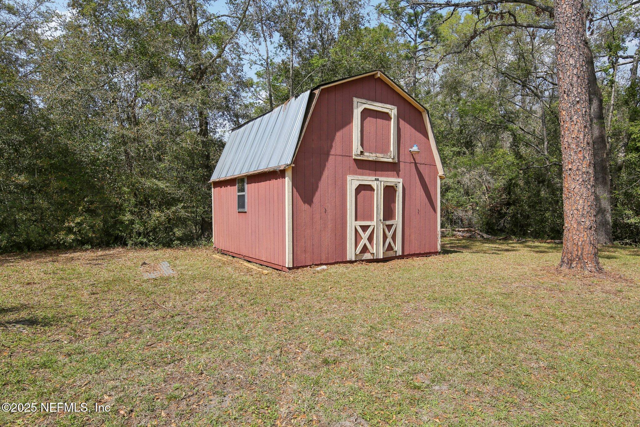 8138 Westport Road Jacksonville, FL 32244 - Photo 29 of 45 a view of a house with a yard and large tree