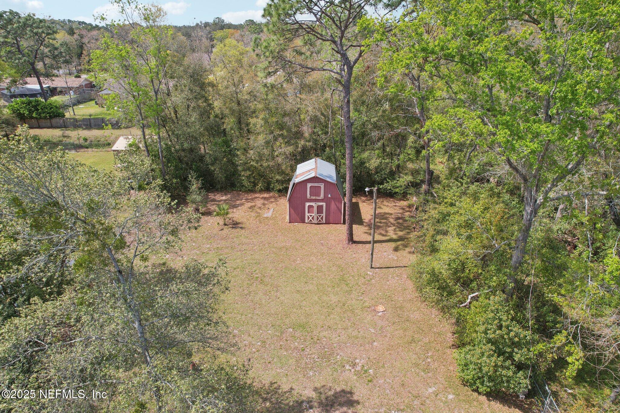 8138 Westport Road Jacksonville, FL 32244 - Photo 38 of 45 a backyard of a house with lots of green space