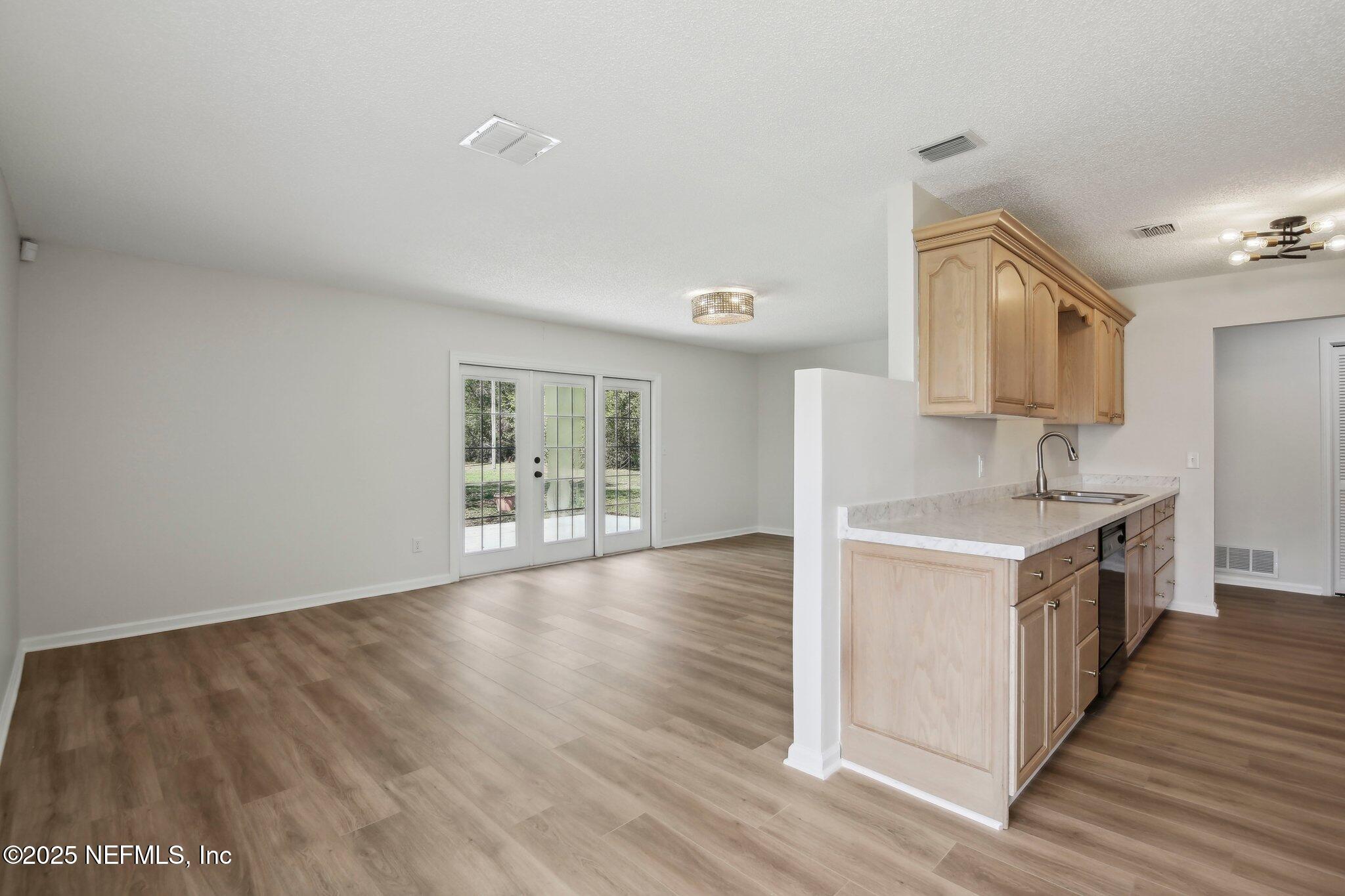 8138 Westport Road Jacksonville, FL 32244 - Photo 8 of 45 a kitchen with wooden floor and window