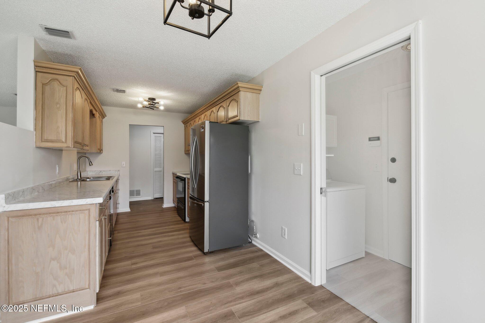 8138 Westport Road Jacksonville, FL 32244 - Photo 9 of 45 a view of a hallway with wooden floor and staircase