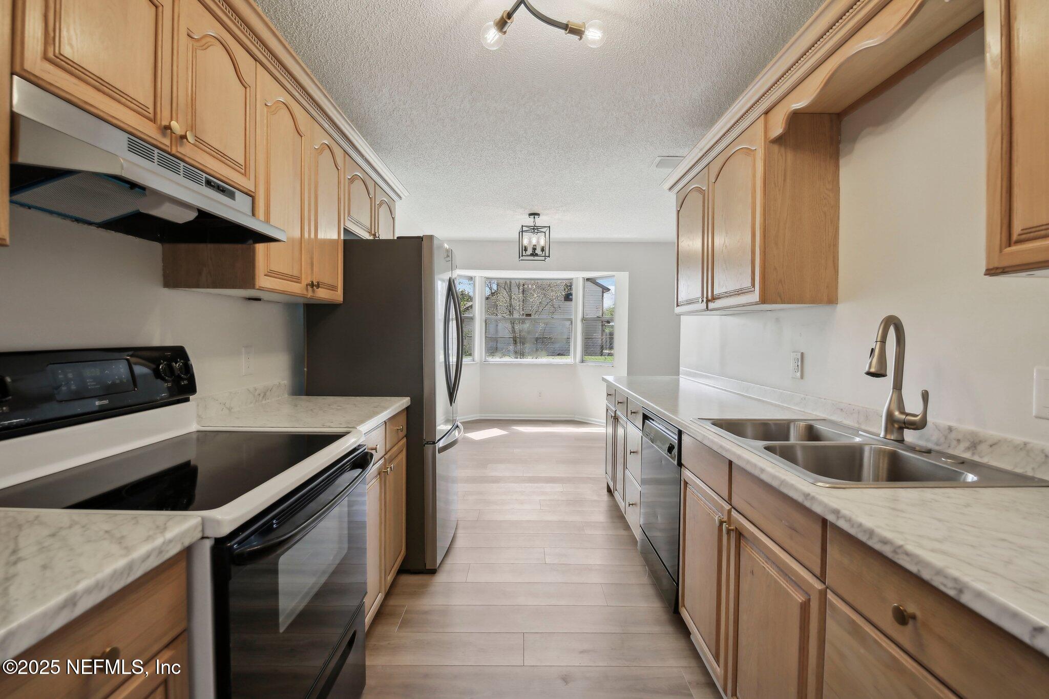 8138 Westport Road Jacksonville, FL 32244 - Photo 10 of 45 a kitchen that has a sink and a stove