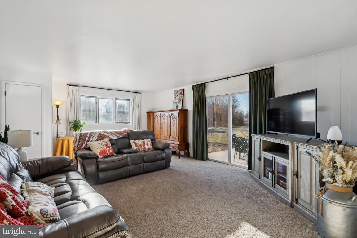 81 Harvard Road Pennsville, NJ 08070 - Photo 11 of 32 a living room with furniture and a flat screen tv