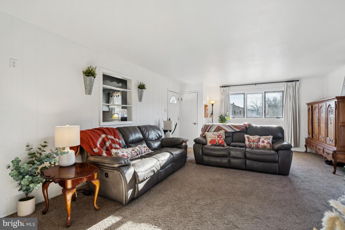 81 Harvard Road Pennsville, NJ 08070 - Photo 12 of 32 a living room with furniture a couch and a flat screen tv