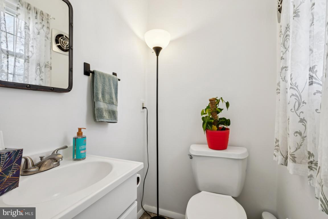81 Harvard Road Pennsville, NJ 08070 - Photo 14 of 32 a bathroom with a toilet sink and mirror