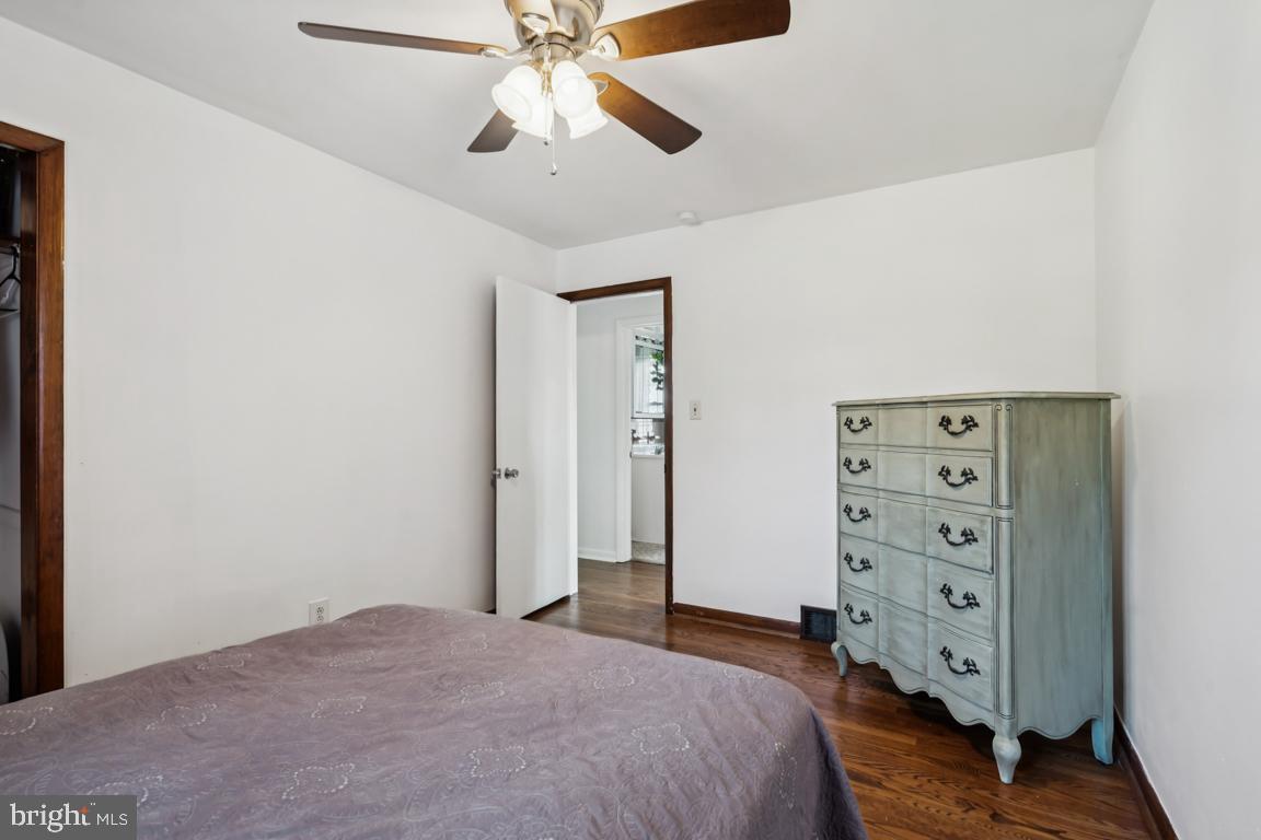 81 Harvard Road Pennsville, NJ 08070 - Photo 16 of 32 a bedroom with a bed and a chandelier