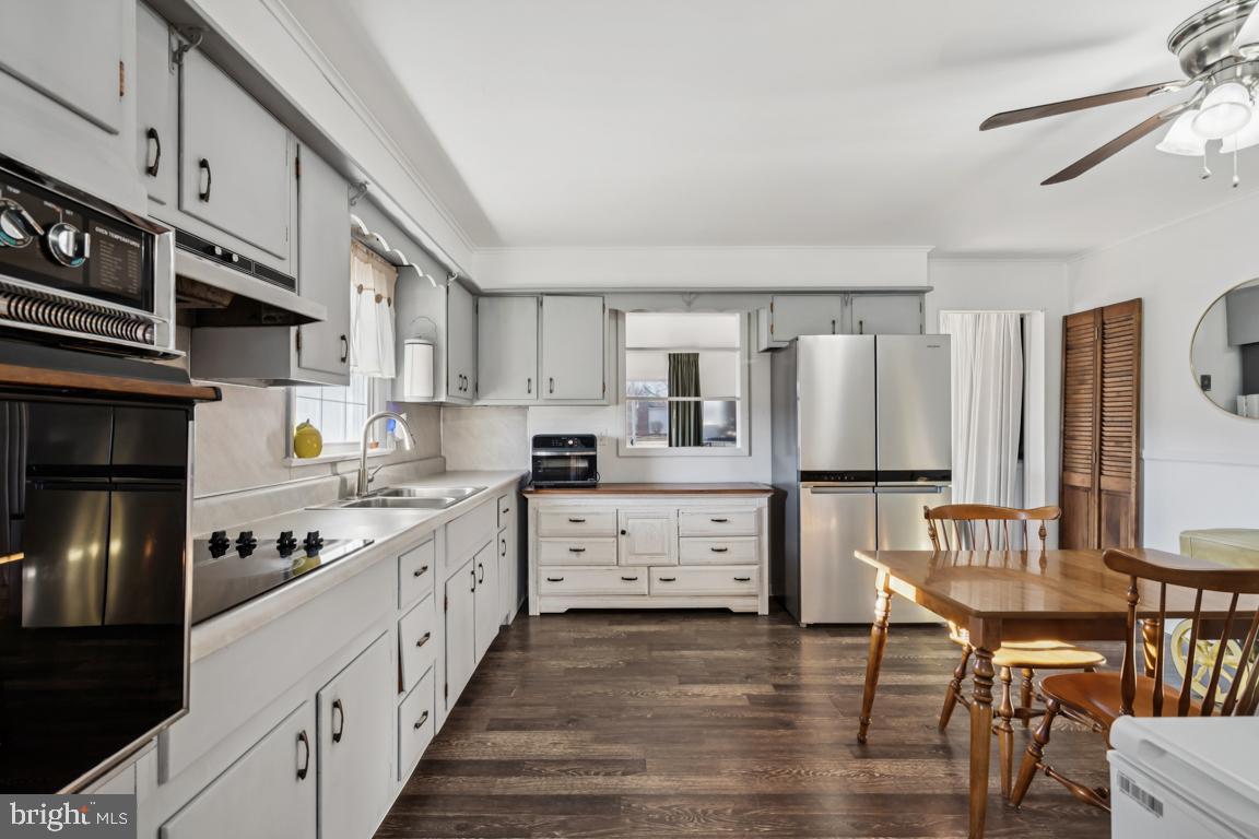 81 Harvard Road Pennsville, NJ 08070 - Photo 6 of 32 a kitchen with white cabinets and appliances