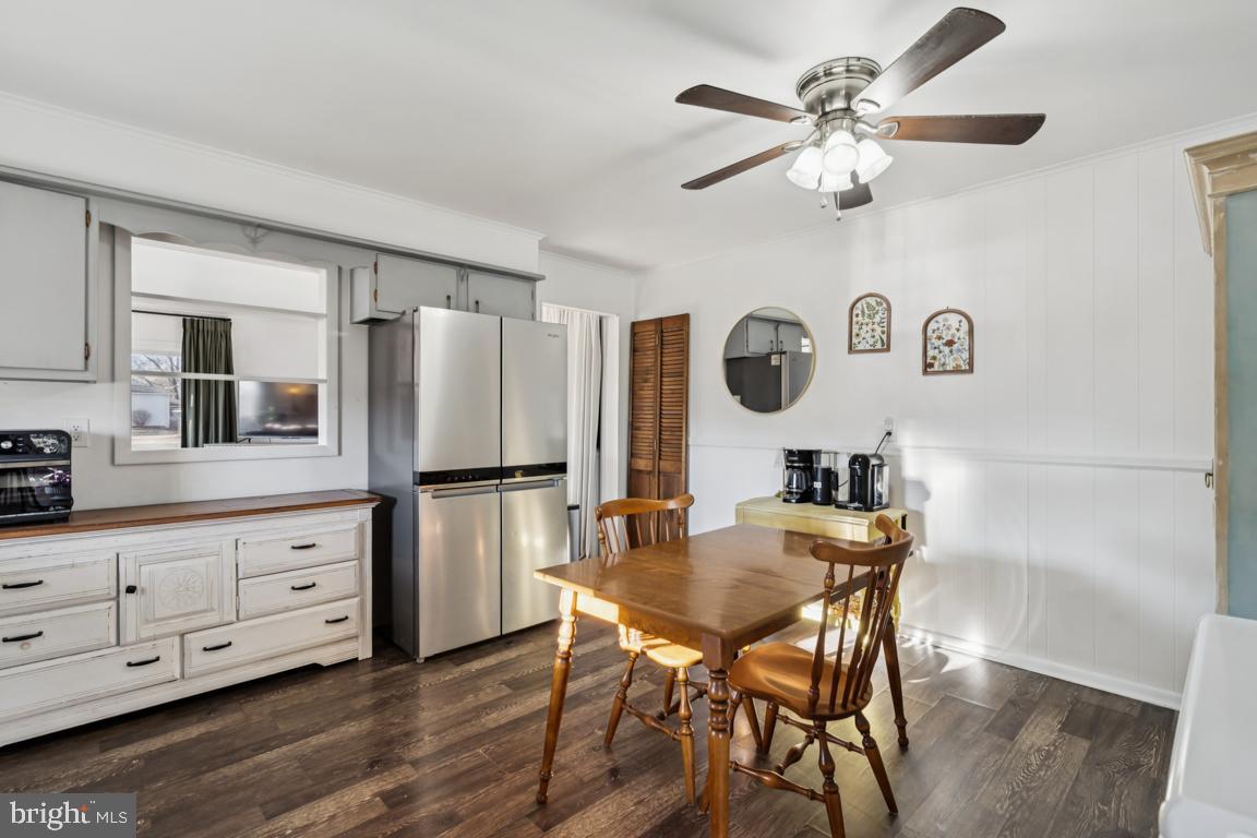 81 Harvard Road Pennsville, NJ 08070 - Photo 7 of 32 a kitchen with a table chairs refrigerator and cabinets