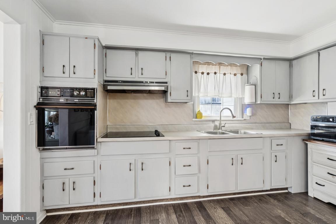 81 Harvard Road Pennsville, NJ 08070 - Photo 9 of 32 a kitchen with granite countertop white cabinets and stainless steel appliances