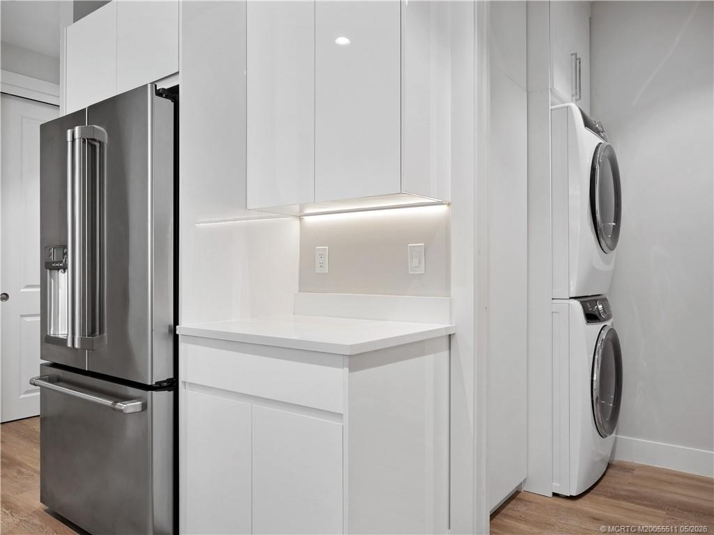 41 Southwest Seminole Street, Unit 208 Stuart, FL 34994 - Photo 9 of 46 a kitchen with a refrigerator and cabinets