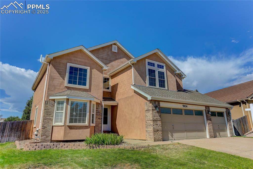 a front view of a house with a yard